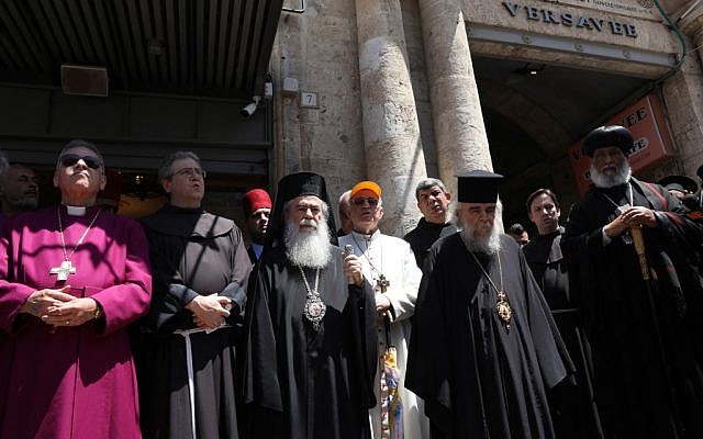 Greek Orthodox Patriarch of Jerusalem Theophilos III (3rd left) together with the Franciscan Custodian of the Holy Land Fr Francesco Patton (2nd left) and fellow church leaders from different denominations hold an ecumenical prayer outside the Petra hostel at Jaffa Gate in Jerusalem's Old City, on July 11, 2019. (GALI TIBBON/AFP)